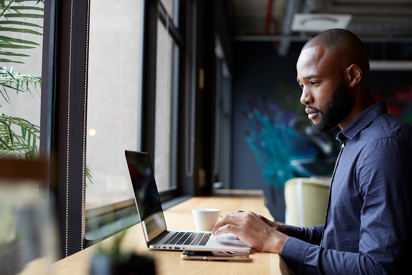 Professional man using a laptop in a calm environment